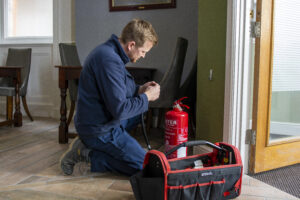 Fire extinguisher engineer checking a water extingisher